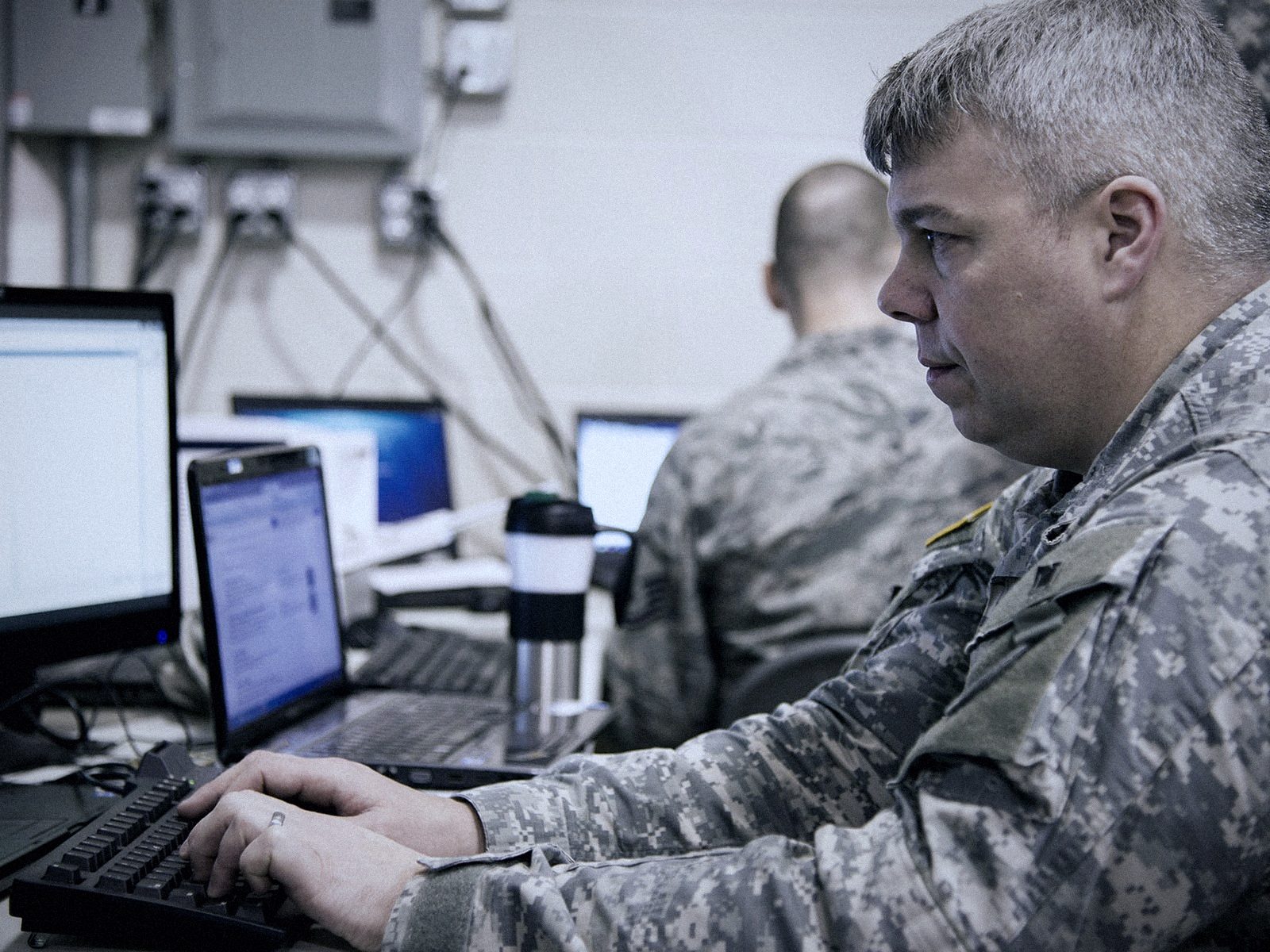 Service member working at a cyber defence station