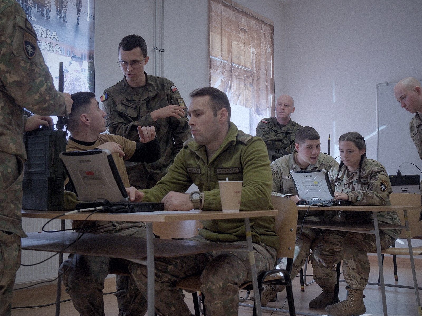 Soldiers configuring radio equipment at a command post
